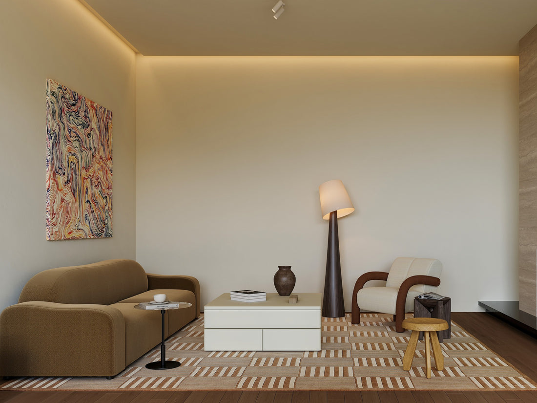 Modern living room with brown sofa, white coffee table, and abstract art on wall.