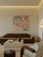 Modern living room with a brown sofa, abstract painting, and decorative items.