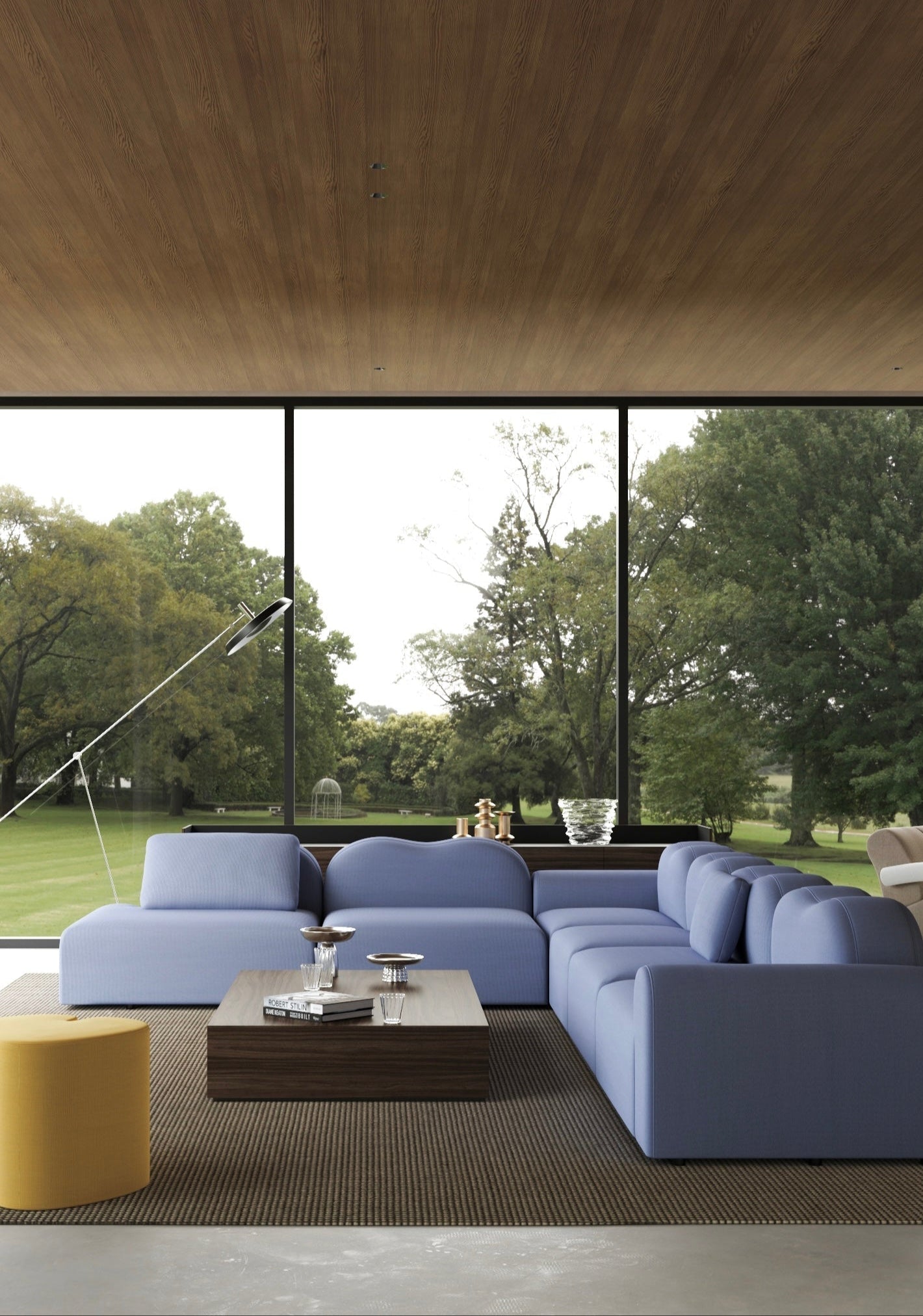 Modern living room with large windows and a view of trees.