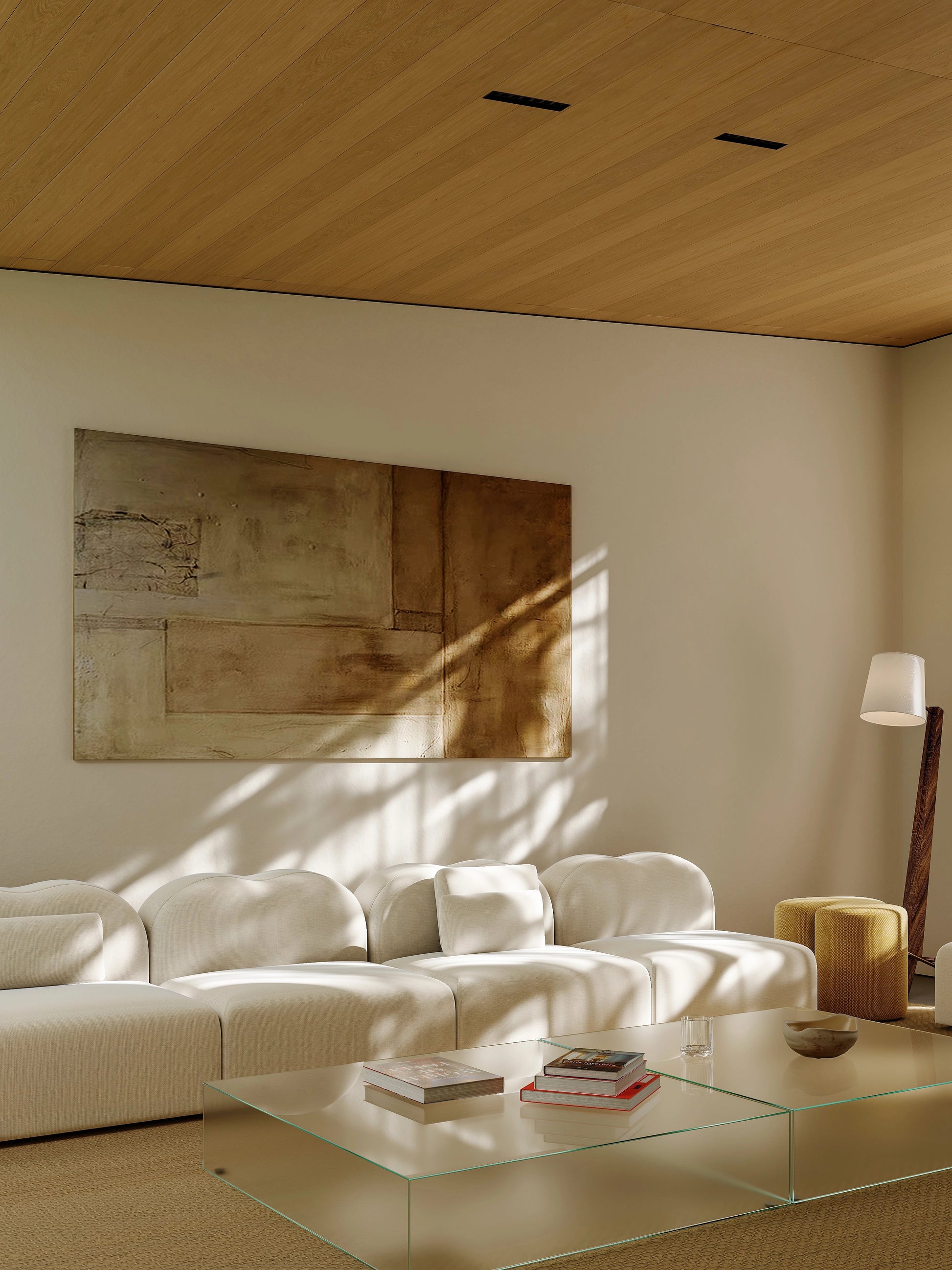 Modern living room with a white sofa, glass coffee table, and abstract painting on the wall.