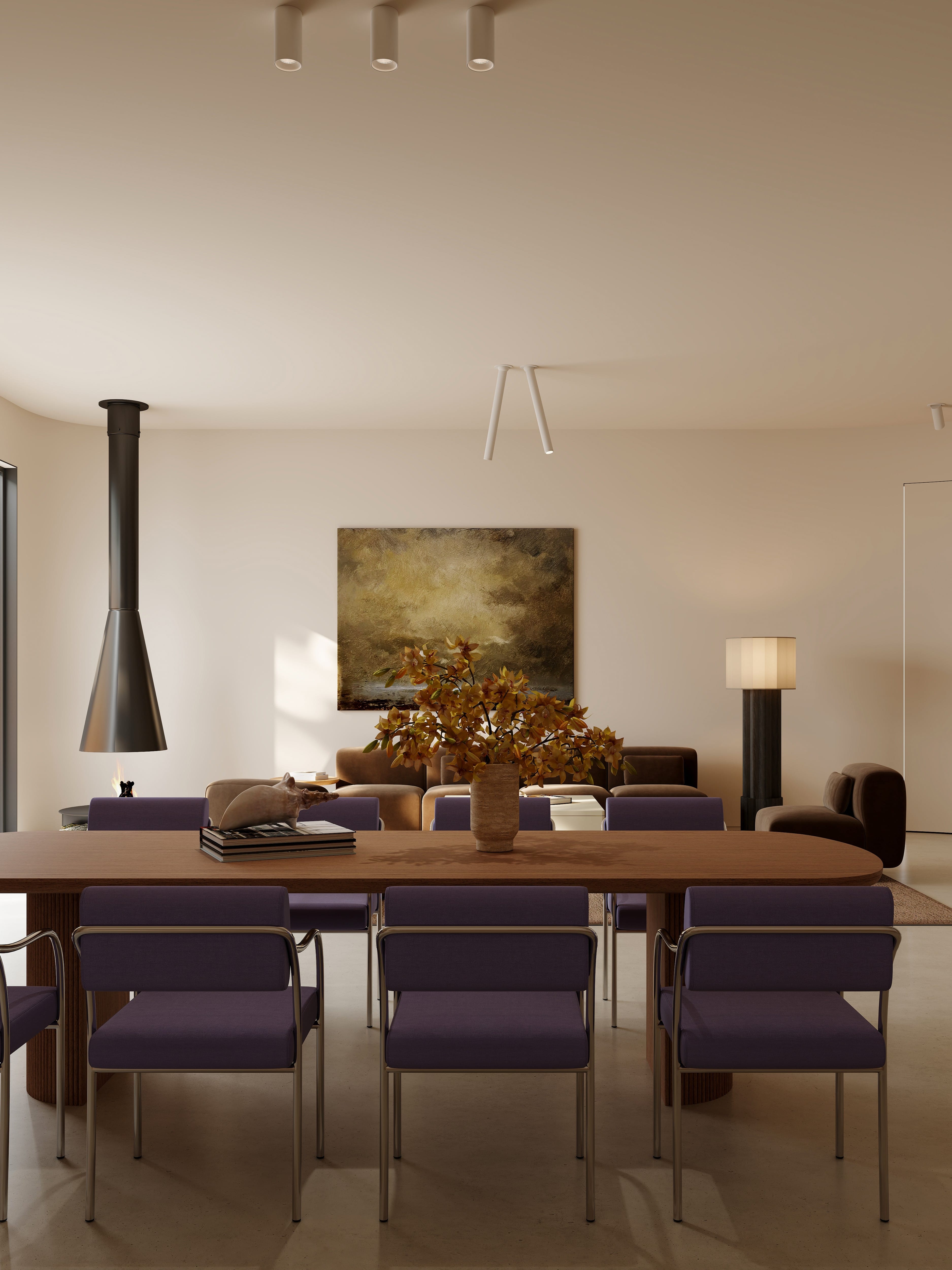 Modern dining room with a long table and chairs, featuring a fireplace and abstract painting.slider_item_aLnHEq